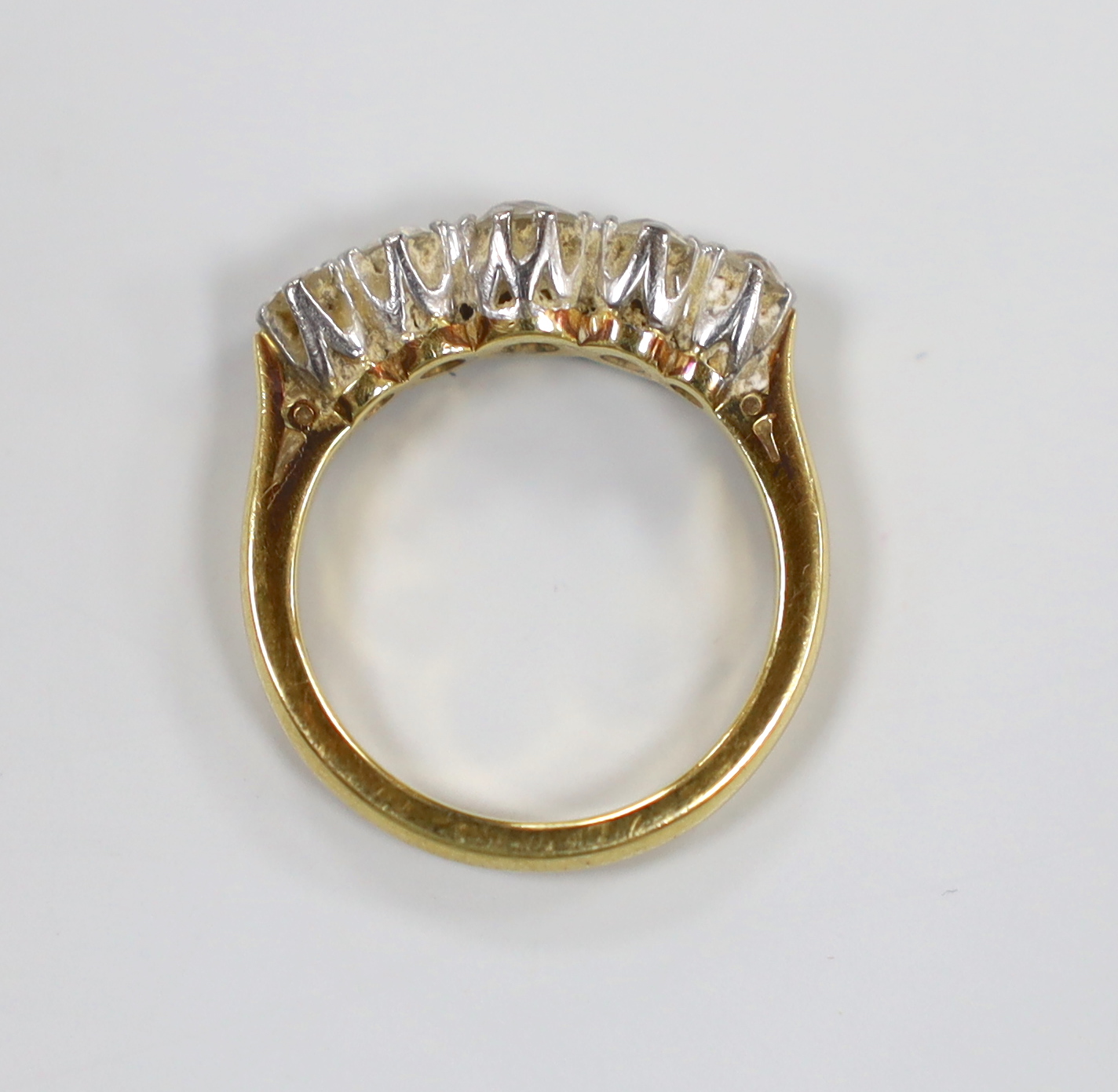 A modern 18ct gold and graduated five stone diamond set half hoop ring, size J, gross weight 3.9 grams.
